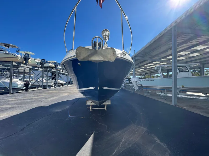 Slide: The Image of 2008 Sea Ray 280 Sundancer boat in storage, front view under clear blue sky. - 6