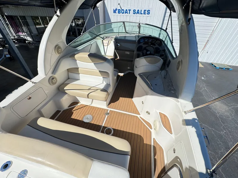Slide: The Image of 2008 Sea Ray 280 Sundancer boat interior with seating and helm, displayed at boat sales. - 9