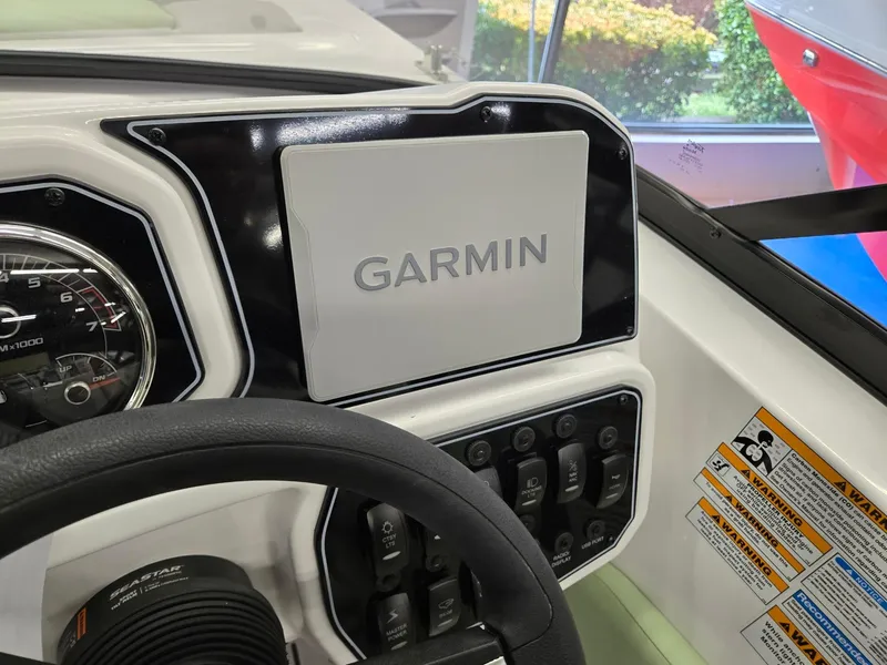 Slide: The Image of 2025 Hurricane SunDeck 2050 OB dashboard with Garmin navigation system. - 11