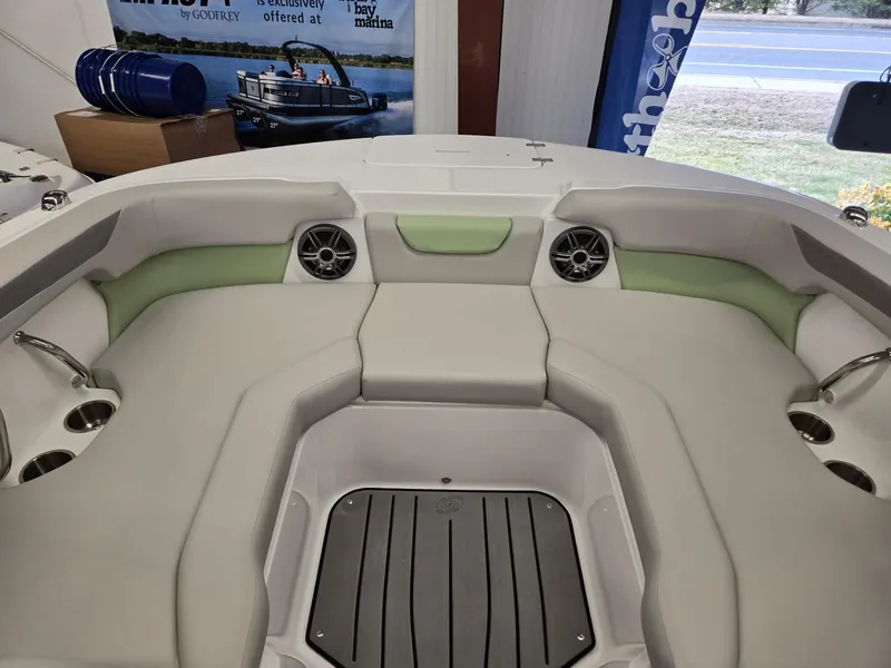 Slide: The Image of 2025 Hurricane SunDeck 2050 OB boat interior with cushioned seating and cup holders. - 23