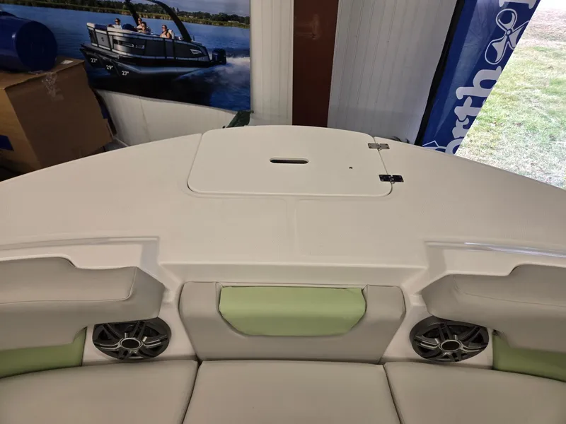 Slide: The Image of 2025 Hurricane SunDeck 2050 OB boat interior with speakers and storage compartment. - 27