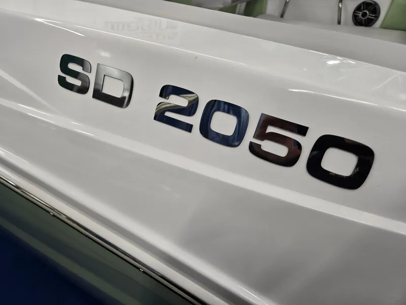 Slide: The Image of 2025 Hurricane SunDeck 2050 OB boat model lettering on white hull. - 29