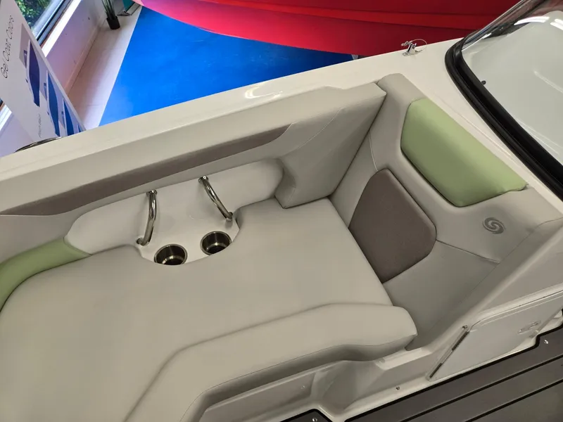 Slide: The Image of 2025 Hurricane SunDeck 2050 OB boat interior with cushioned seating and cup holders. - 5