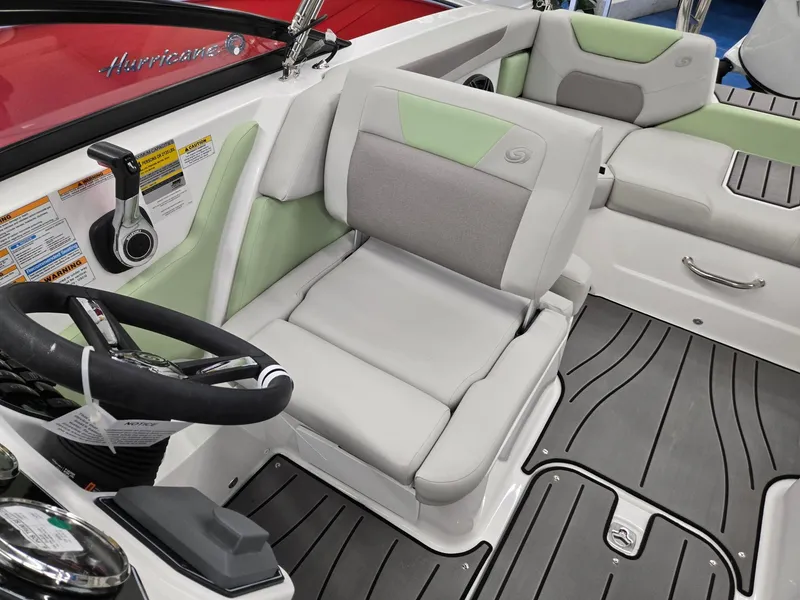Slide: The Image of 2025 Hurricane SunDeck 2050 OB boat interior with gray and green seating, steering wheel, and controls. - 9