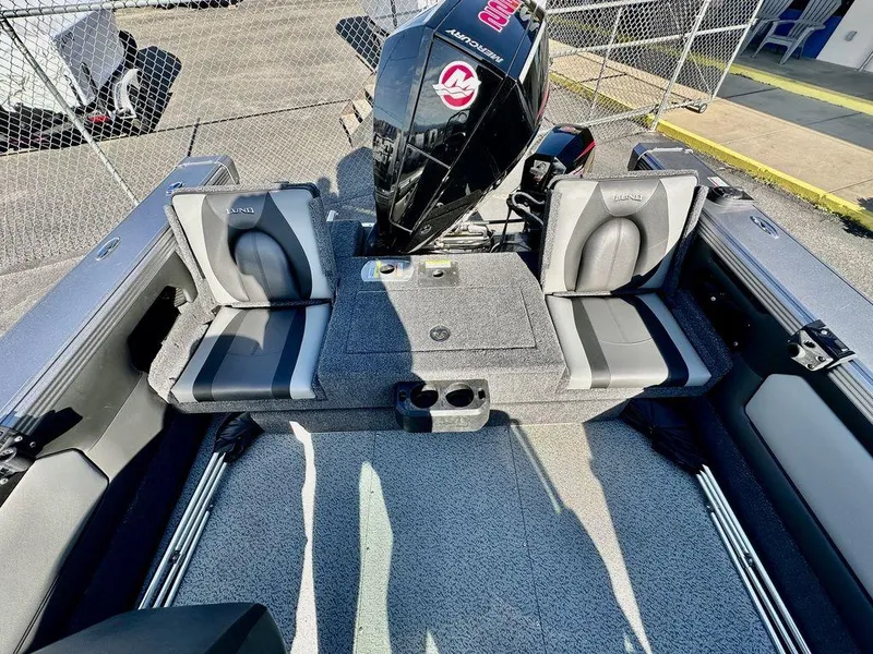 Slide: The Image of 2024 Lund 1975 Tyee Sport boat interior with seating and motor. - 10