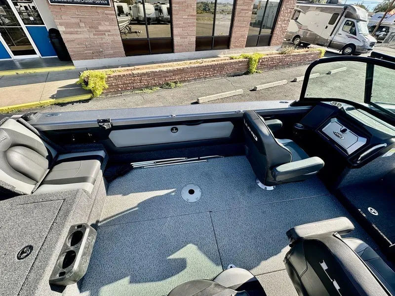 Slide: The Image of 2024 Lund 1975 Tyee Sport boat interior with seating and dashboard view. - 12