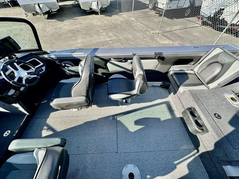 Slide: The Image of Interior of 2024 Lund 1975 Tyee Sport boat with seating and steering wheel. - 14
