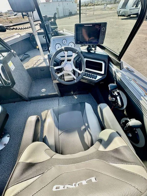 Slide: The Image of 2024 Lund 1975 Tyee Sport boat interior with modern dashboard and steering wheel. - 15