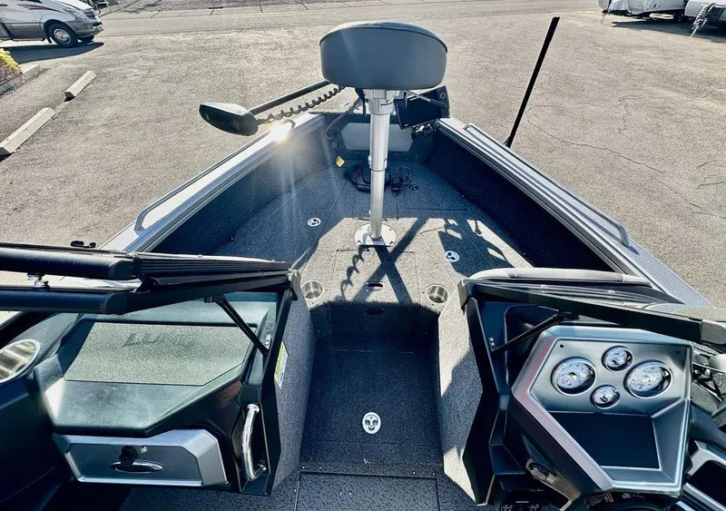 Slide: The Image of 2024 Lund 1975 Tyee Sport boat interior with steering console and seating. - 16