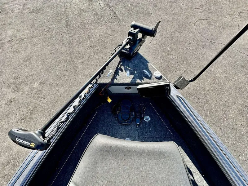 Slide: The Image of 2024 Lund 1975 Tyee Sport boat with trolling motor and control panel. - 17