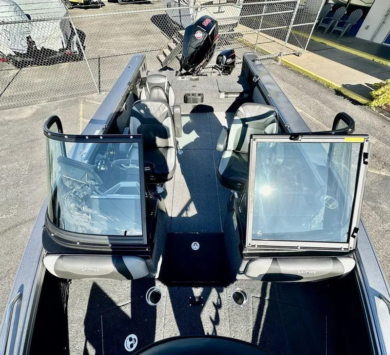 Slide: The Image of 2024 Lund 1975 Tyee Sport boat interior with open windshield and seating. - 18