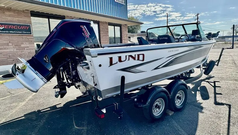 Slide: The Image of 2024 Lund 1975 Tyee Sport boat with powerful outboard motor on trailer. - 3
