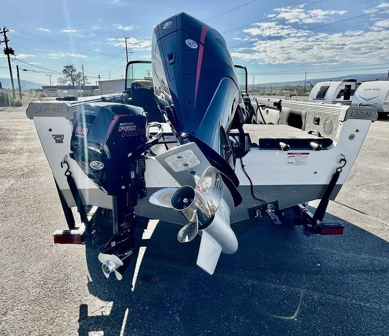 Slide: The Image of 2024 Lund 1975 Tyee Sport boat with dual Mercury outboard motors. - 4