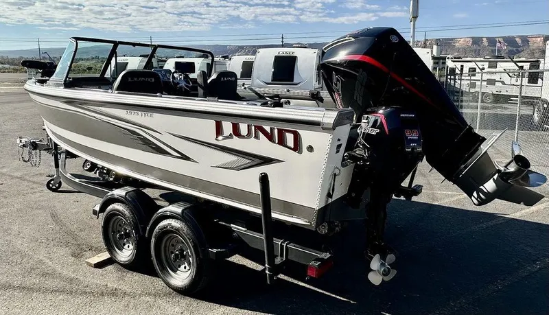 Slide: The Image of 2024 Lund 1975 Tyee Sport boat on trailer, parked outdoors. - 5