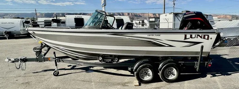 Slide: The Image of 2024 Lund 1975 Tyee Sport boat on trailer, parked outdoors. - 6
