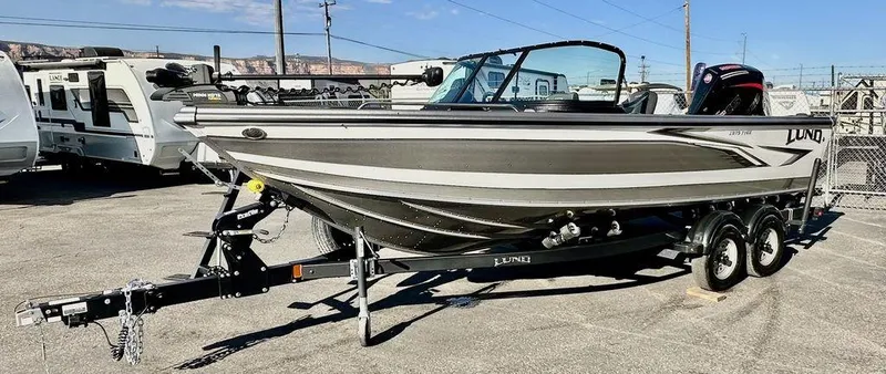 Slide: The Image of 2024 Lund 1975 Tyee Sport boat on trailer in outdoor setting. - 7