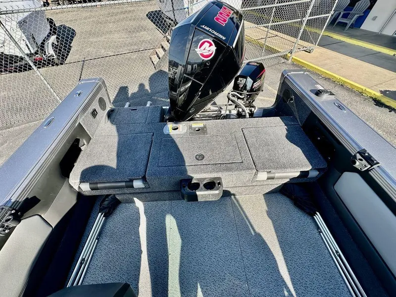 Slide: The Image of 2024 Lund 1975 Tyee Sport boat with powerful outboard motor, spacious deck, and sleek design. - 8