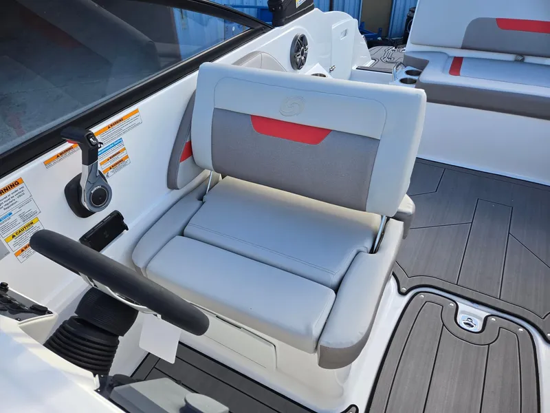 Slide: The Image of 2025 Hurricane SunDeck 235 OB boat interior with gray and red seating, modern design. - 13