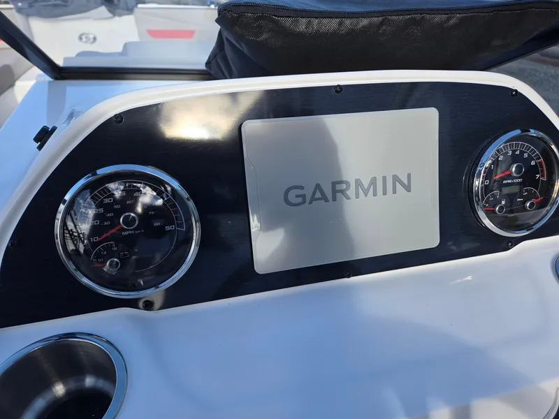 Slide: The Image of 2025 Hurricane SunDeck 235 OB dashboard with Garmin display and gauges. - 15