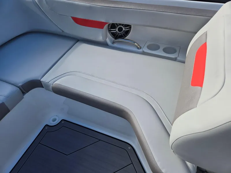 Slide: The Image of 2025 Hurricane SunDeck 235 OB interior seating with cup holders and speaker. - 23