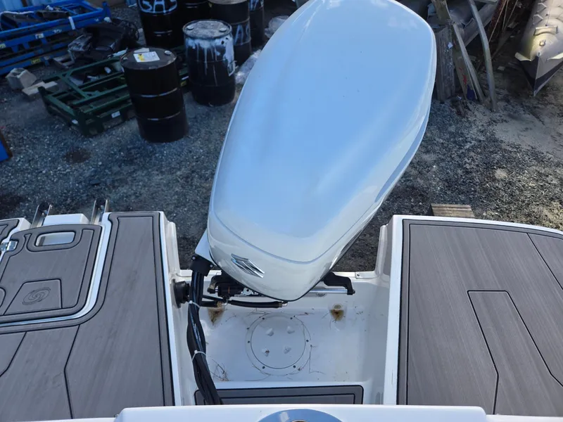Slide: The Image of 2025 Hurricane SunDeck 235 OB boat engine and deck, outdoor setting. - 29
