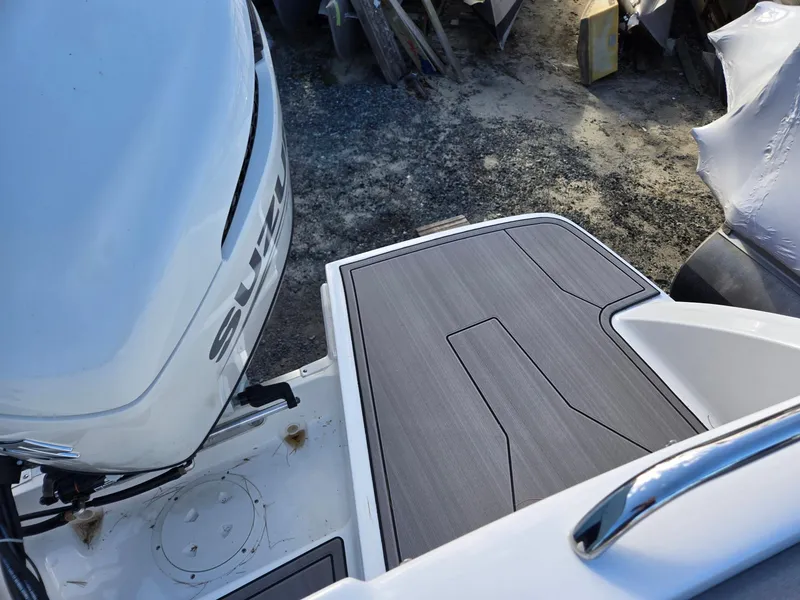 Slide: The Image of 2025 Hurricane SunDeck 235 OB boat with Suzuki outboard motor and sleek deck design. - 31