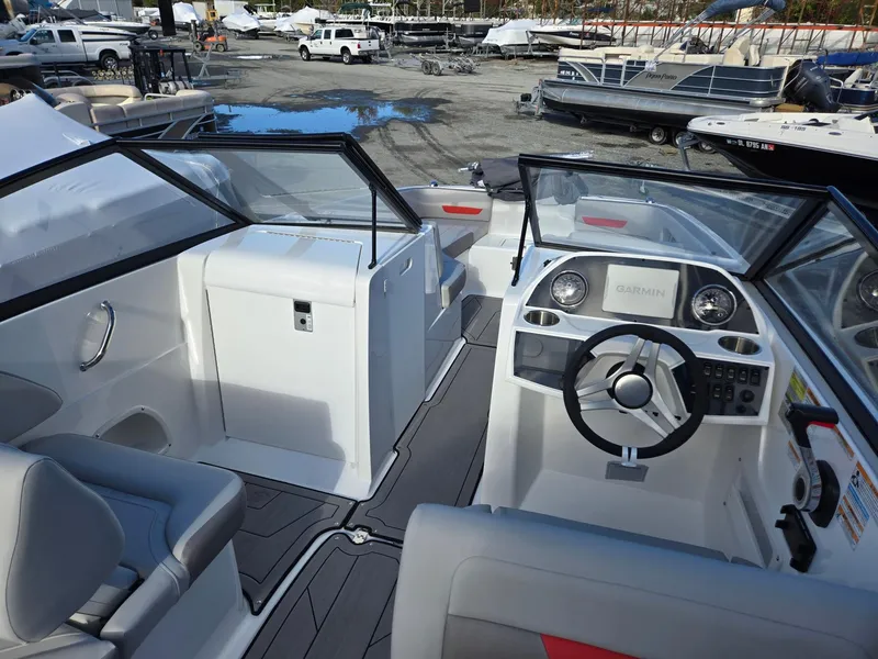 Slide: The Image of 2025 Hurricane SunDeck 235 OB boat interior with modern dashboard and seating. - 32
