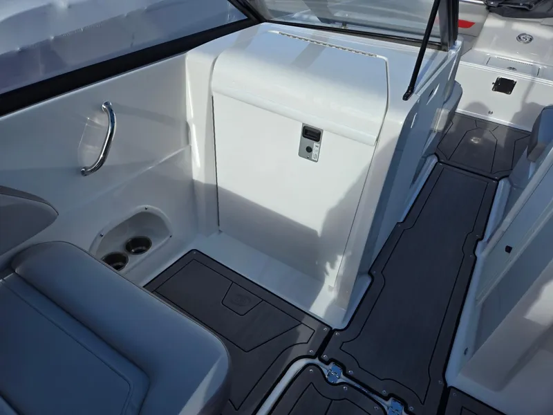 Slide: The Image of 2025 Hurricane SunDeck 235 OB interior with seating and storage compartments. - 37