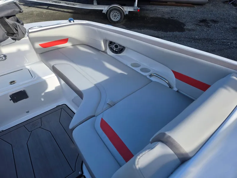 Slide: The Image of 2025 Hurricane SunDeck 235 OB boat interior with gray and red seating, cup holders, and speaker. - 41