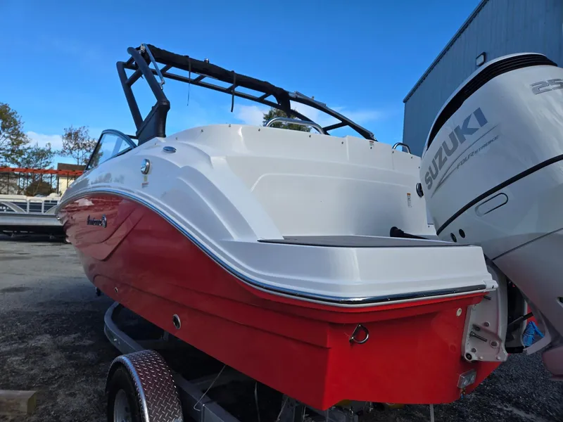 Slide: The Image of 2025 Hurricane SunDeck 235 OB boat with Suzuki outboard motor, red and white design. - 6