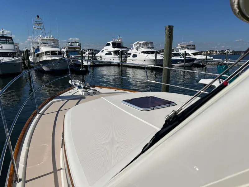 Slide: The Image of 2004 Sabre 36 Sedan yacht docked at marina with other boats under clear blue sky. - 10