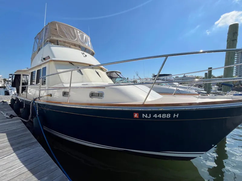 Slide: The Image of 2004 Sabre 36 Sedan boat docked at marina under clear blue sky. - 12