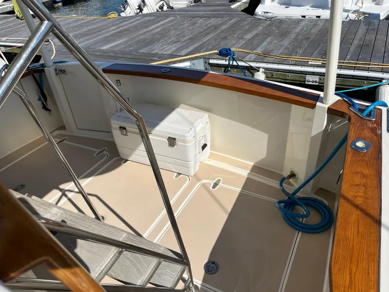 Slide: The Image of 2004 Sabre 36 Sedan boat deck with cooler and dock view. - 14