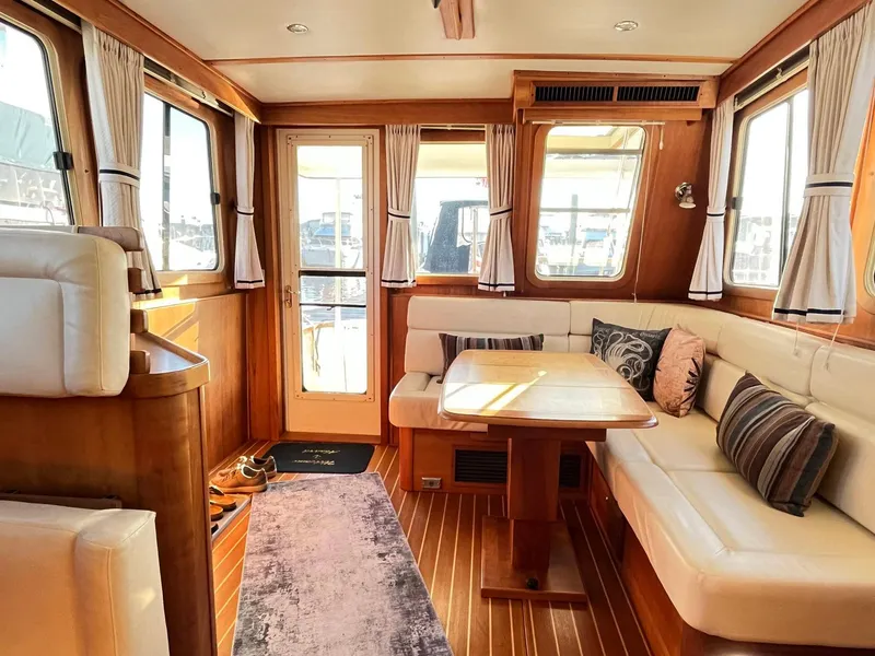 Slide: The Image of Interior of 2004 Sabre 36 Sedan with cozy seating and wooden accents. - 15