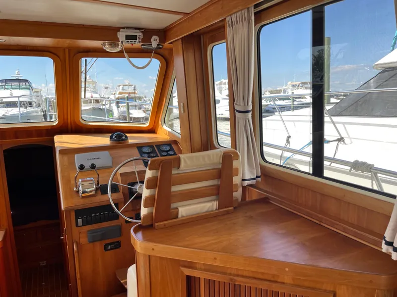 Slide: The Image of Interior of 2004 Sabre 36 Sedan yacht with wooden helm and marina view. - 19