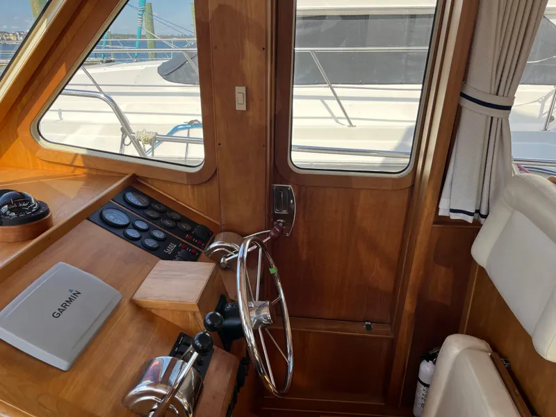 Slide: The Image of 2004 Sabre 36 Sedan helm with wooden interior and Garmin navigation system. - 21