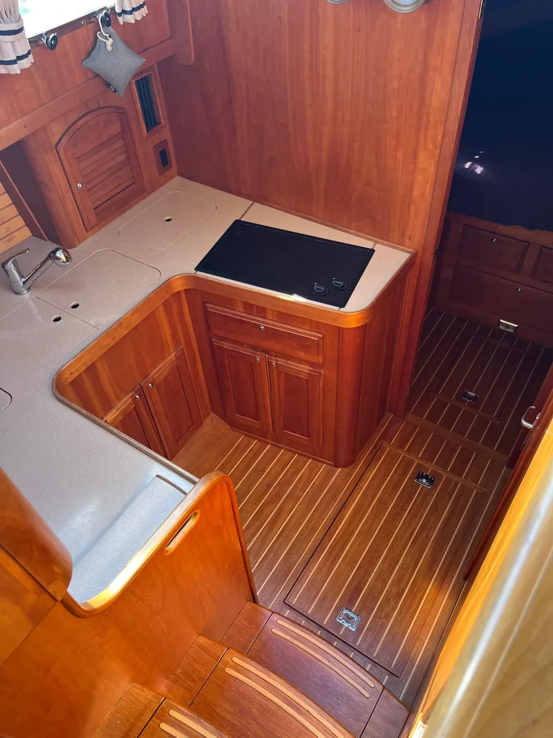 Slide: The Image of 2004 Sabre 36 Sedan yacht interior with wooden cabinetry and flooring. - 24