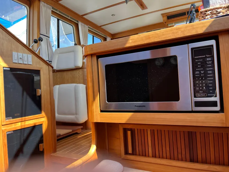 Slide: The Image of Interior of 2004 Sabre 36 Sedan with microwave and seating area. - 27