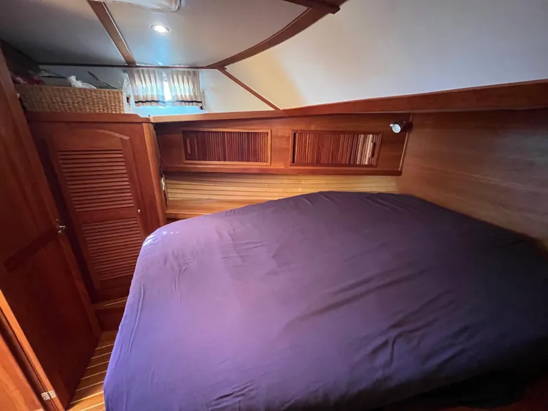 Slide: The Image of Cozy cabin interior of 2004 Sabre 36 Sedan with wooden accents and bed. - 29