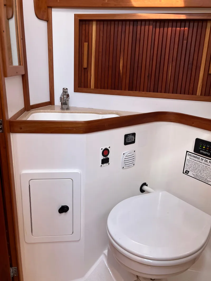 Slide: The Image of 2004 Sabre 36 Sedan yacht bathroom with wood accents and modern fixtures. - 31