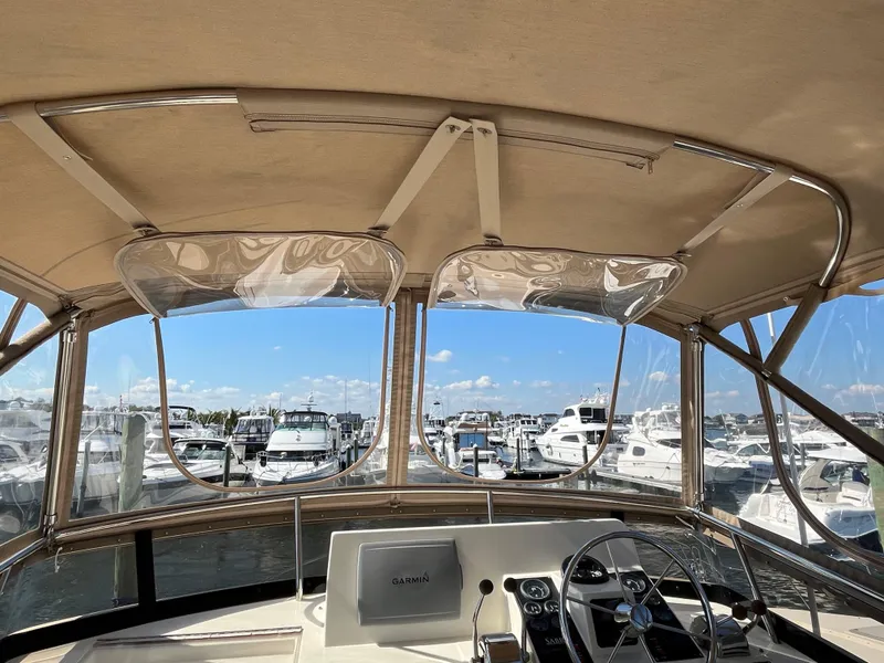 Slide: The Image of View from 2004 Sabre 36 Sedan helm, overlooking marina with multiple boats docked. - 33