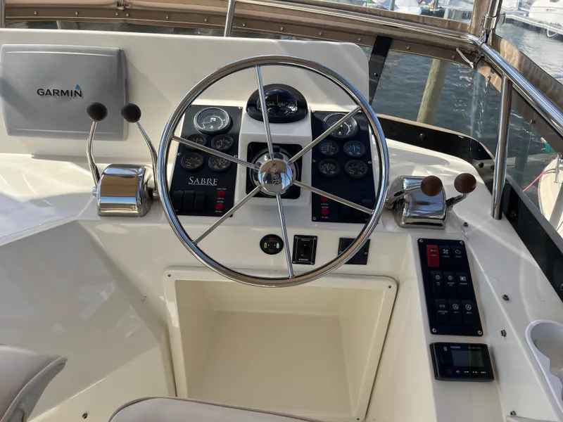 Slide: The Image of 2004 Sabre 36 Sedan helm with Garmin navigation system and classic steering wheel. - 35