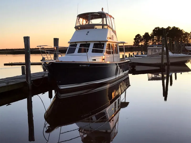 Slide: The Image of 2004 Sabre 36 Sedan yacht docked at sunset, reflecting on calm water. - 39