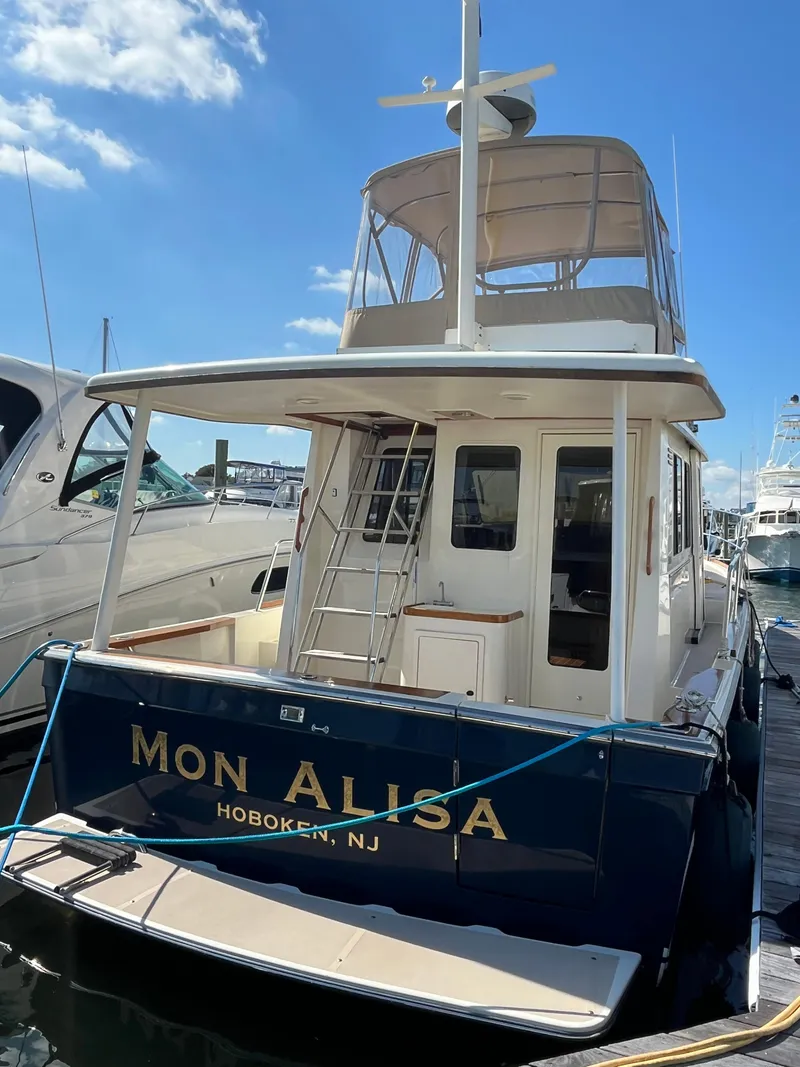 Slide: The Image of 2004 Sabre 36 Sedan boat docked in Hoboken, NJ under clear blue sky. - 4
