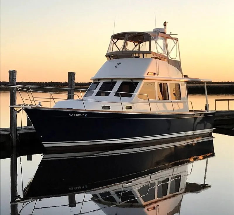 Slide: The Image of 2004 Sabre 36 Sedan yacht docked at sunset, reflecting on calm water. - 40
