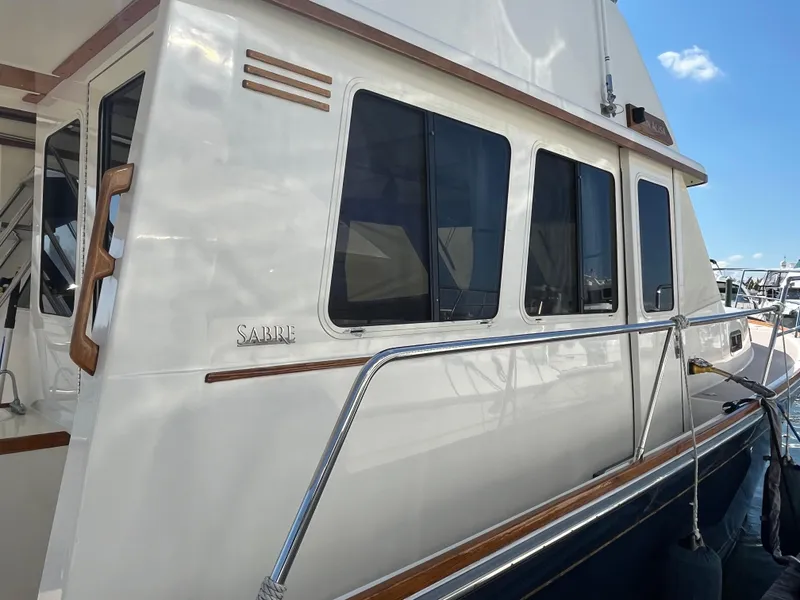 Slide: The Image of 2004 Sabre 36 Sedan yacht with sleek white exterior and tinted windows. - 7