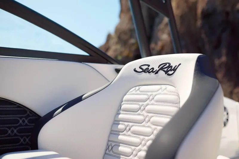 Slide: The Image of 2024 Sea Ray 210SPX boat seat with logo, featuring stylish white and black design. - 10
