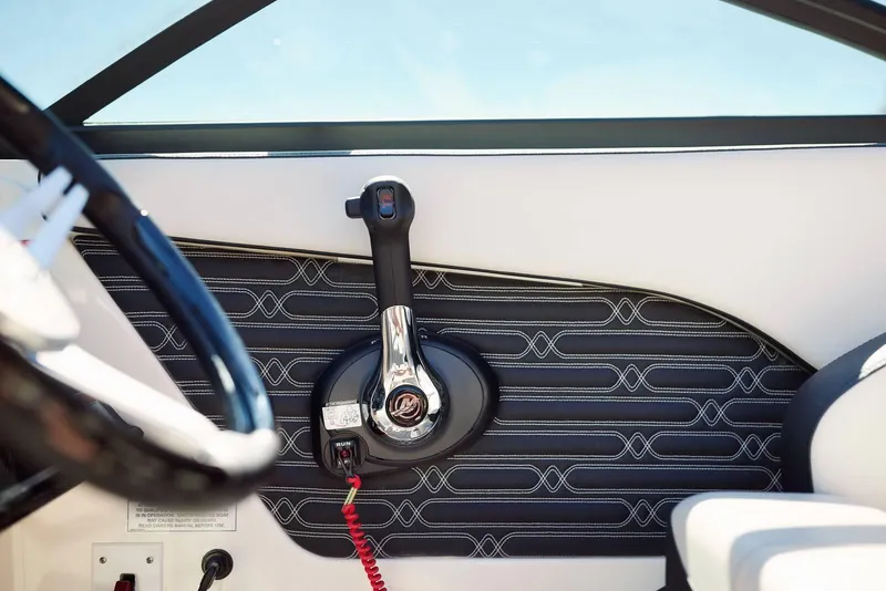 Slide: The Image of 2024 Sea Ray 210SPX boat interior with steering wheel and throttle control. - 11