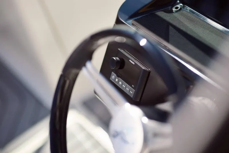 Slide: The Image of Close-up of 2024 Sea Ray 210SPX steering wheel and control panel. - 12