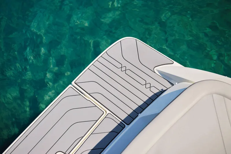 Slide: The Image of 2024 Sea Ray 210SPX boat deck above clear turquoise water. - 22